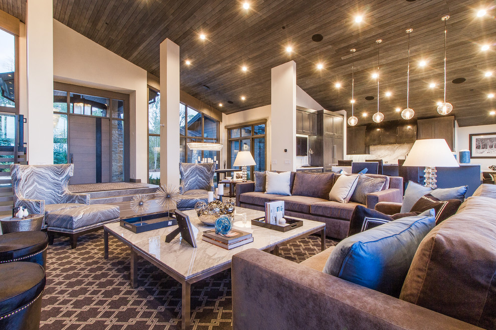 Expansive modern open plan living room in Salt Lake City with white walls and a metal fireplace surround.