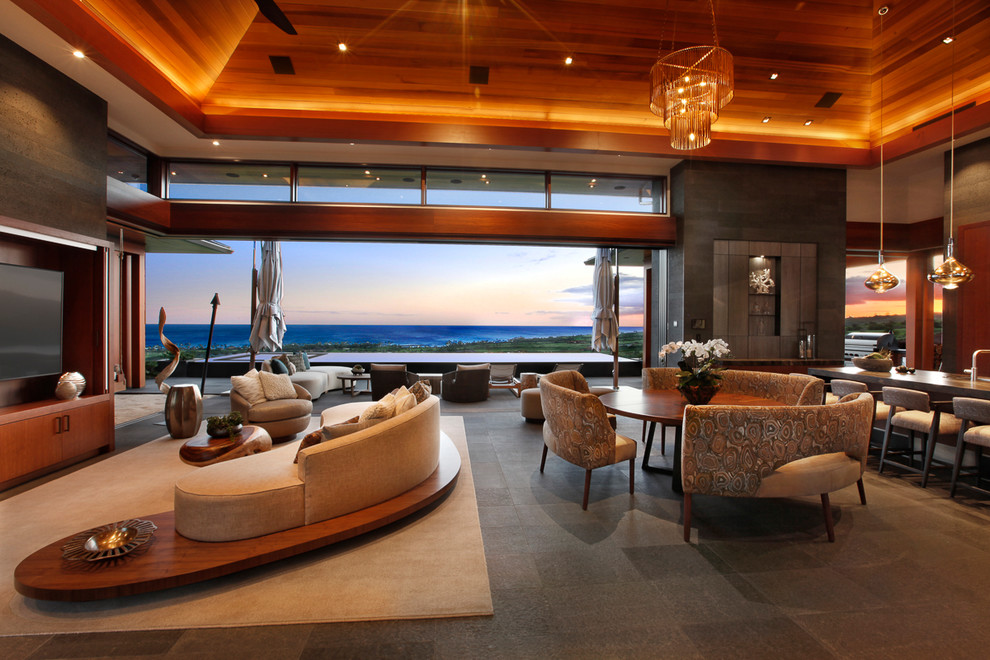 Living room - large tropical open concept living room idea in Hawaii with gray walls, no fireplace and a media wall