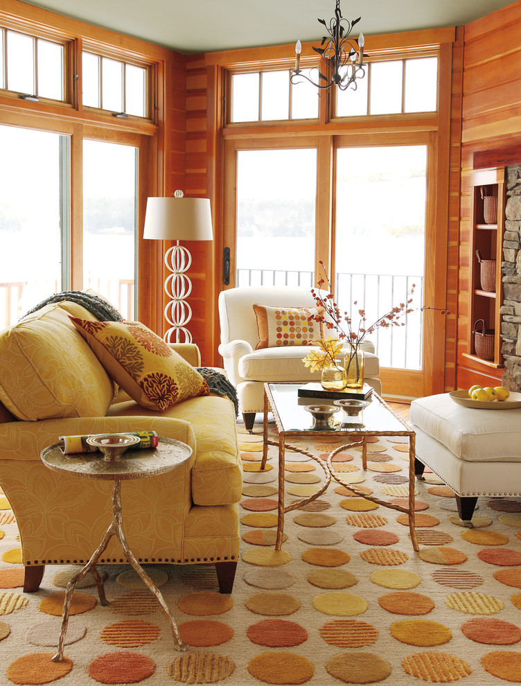 Example of a mid-sized trendy formal and enclosed medium tone wood floor and brown floor living room design in Boston with brown walls, a standard fireplace, a stone fireplace and no tv