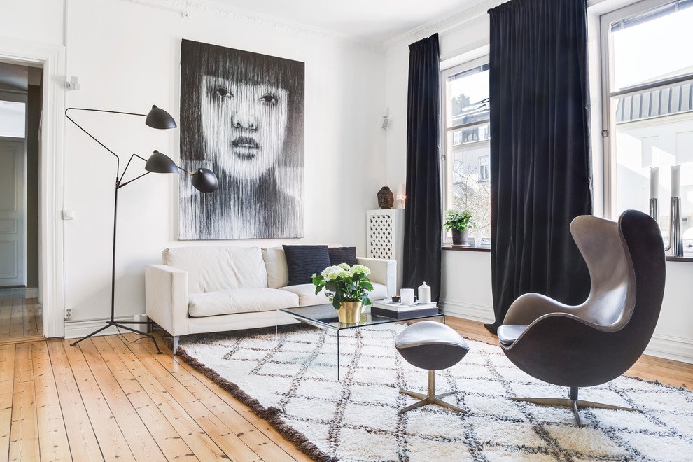Living room - small scandinavian open concept light wood floor and beige floor living room idea in London with white walls