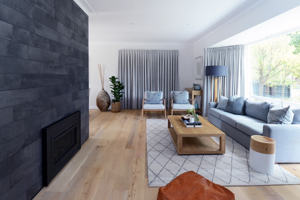 Mittelgroßes Modernes Wohnzimmer mit weißer Wandfarbe, hellem Holzboden, Kamin und beigem Boden in Sydney