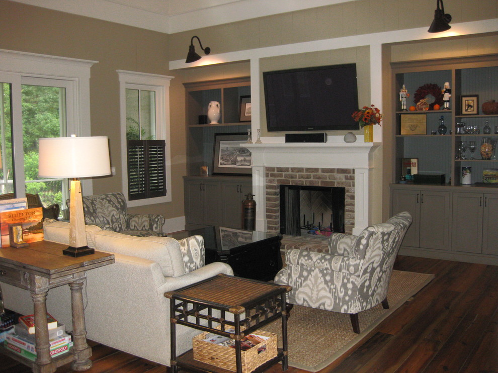 Design ideas for a medium sized traditional open plan living room in Atlanta with beige walls, light hardwood flooring, a standard fireplace, a brick fireplace surround and a wall mounted tv.