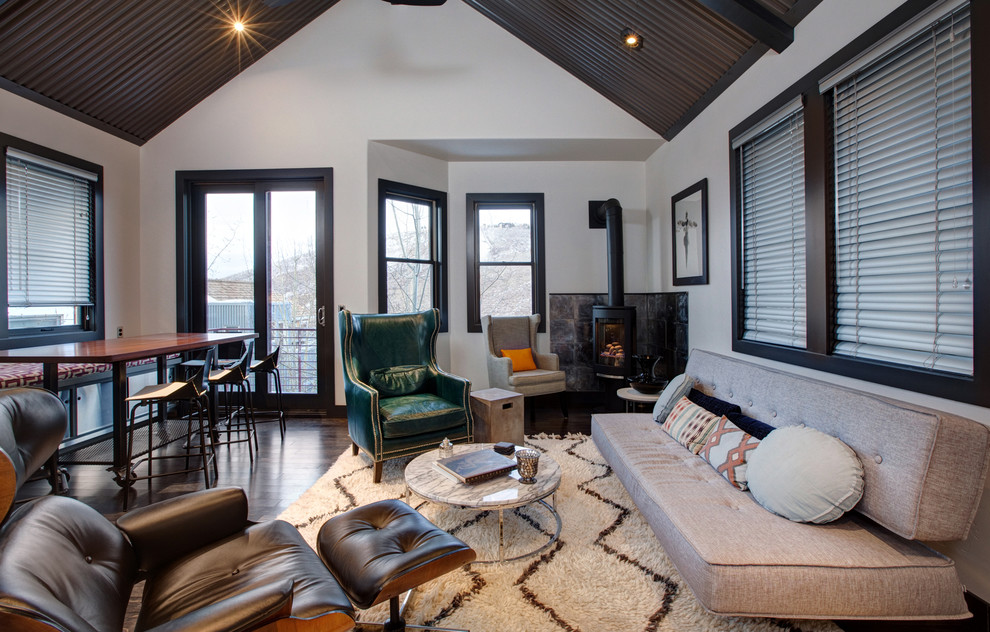 Contemporary living room in Salt Lake City with a wood burning stove.