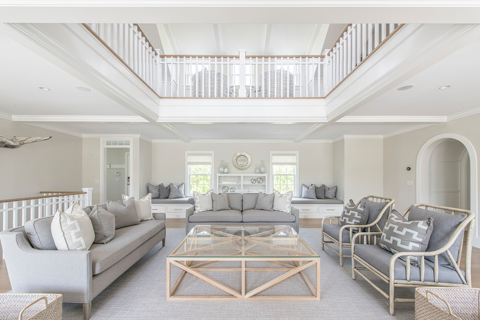 This is an example of an expansive nautical open plan living room in Boston with a stone fireplace surround and a wall mounted tv.