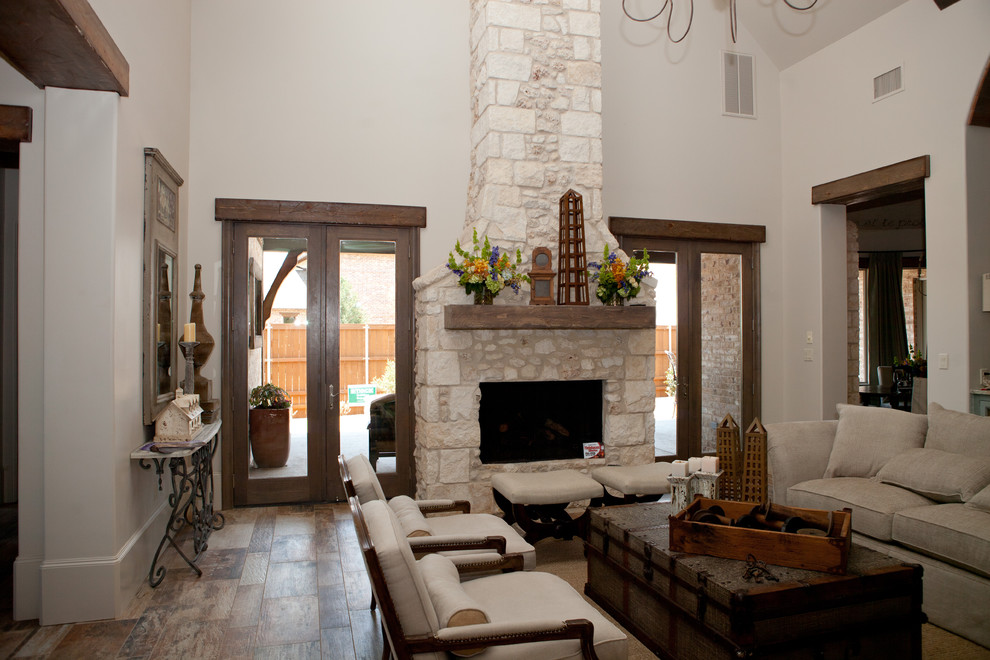 Living room - large traditional open concept vinyl floor and multicolored floor living room idea in Dallas with white walls, a standard fireplace, a stone fireplace and a wall-mounted tv