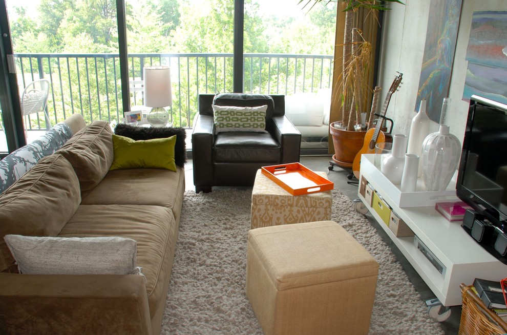 Inspiration for an eclectic living room in Atlanta with white walls and a freestanding tv.