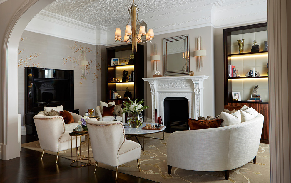 Example of a classic enclosed dark wood floor living room design in London with gray walls and a standard fireplace