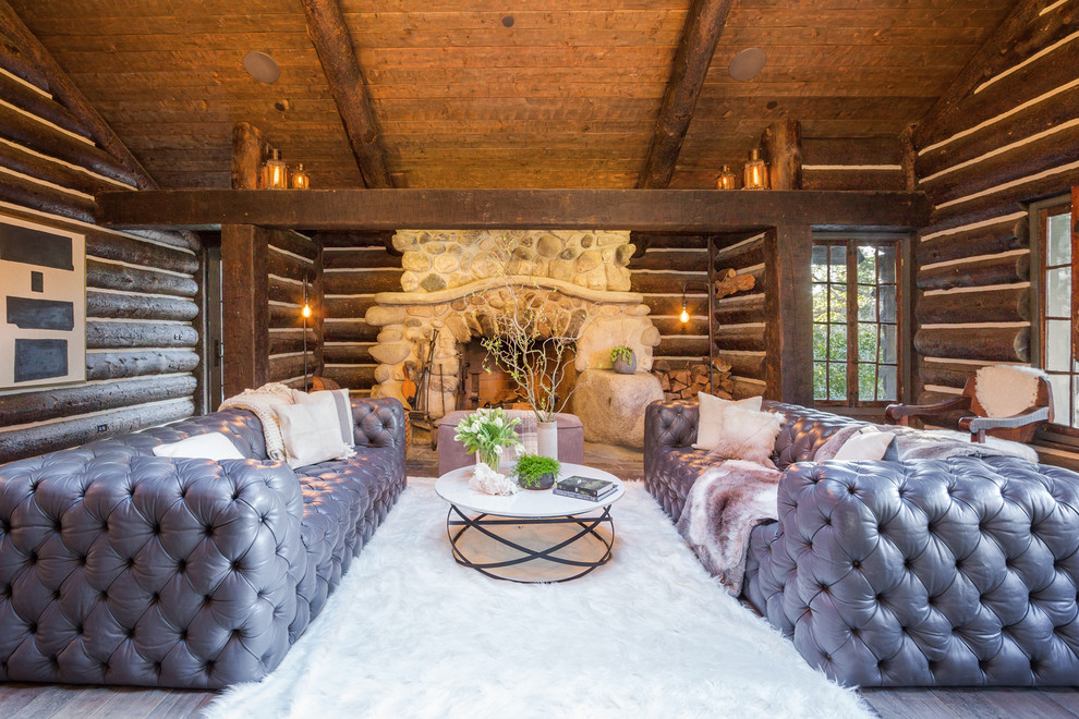 Photo of a rustic formal living room in Los Angeles with a standard fireplace and a stone fireplace surround.