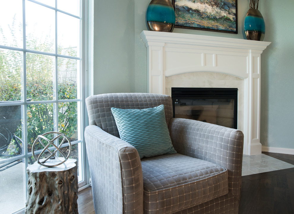 This is an example of a medium sized beach style grey and teal open plan living room in Milwaukee with blue walls, dark hardwood flooring, a corner fireplace, a tiled fireplace surround and a freestanding tv.