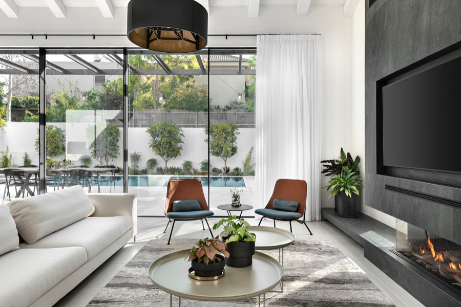 Inspiration for a mid-sized modern open concept porcelain tile and gray floor living room remodel in Tel Aviv with black walls, a two-sided fireplace, a tile fireplace and a media wall
