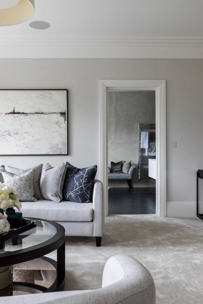 This is an example of a large contemporary open plan living room in London with grey walls, carpet and grey floors.