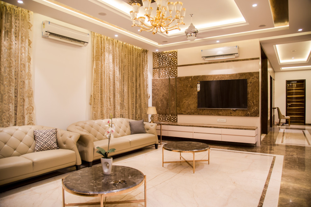 This is an example of an eclectic formal enclosed living room in Pune with beige walls, marble flooring and a wall mounted tv.
