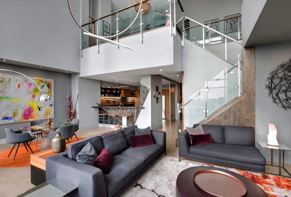 Photo of a medium sized modern formal mezzanine living room with grey walls, light hardwood flooring, a standard fireplace, a tiled fireplace surround, a wall mounted tv and grey floors.