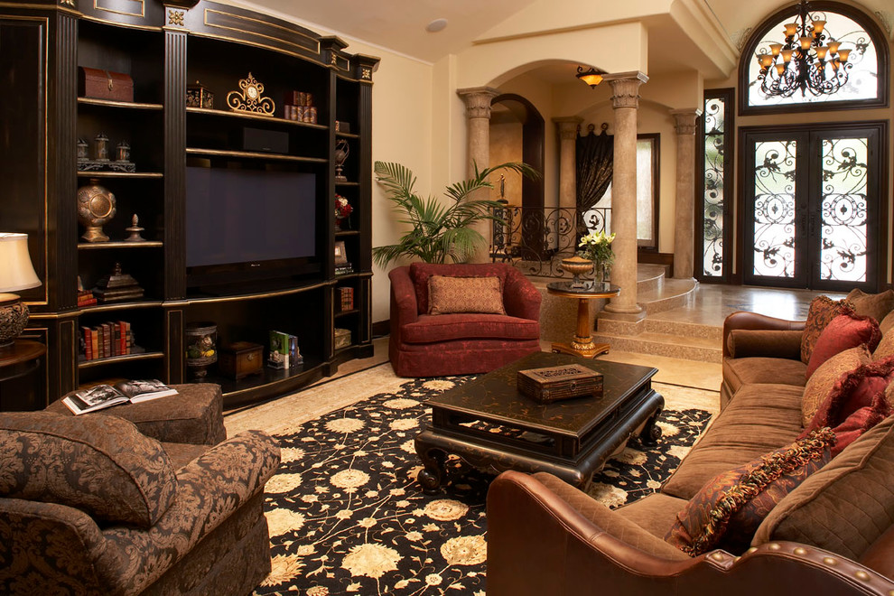 Large tuscan open concept ceramic tile living room photo in Los Angeles with beige walls, no fireplace and a media wall