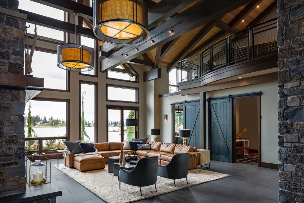 Rustic open plan living room in Seattle with beige walls and grey floors.