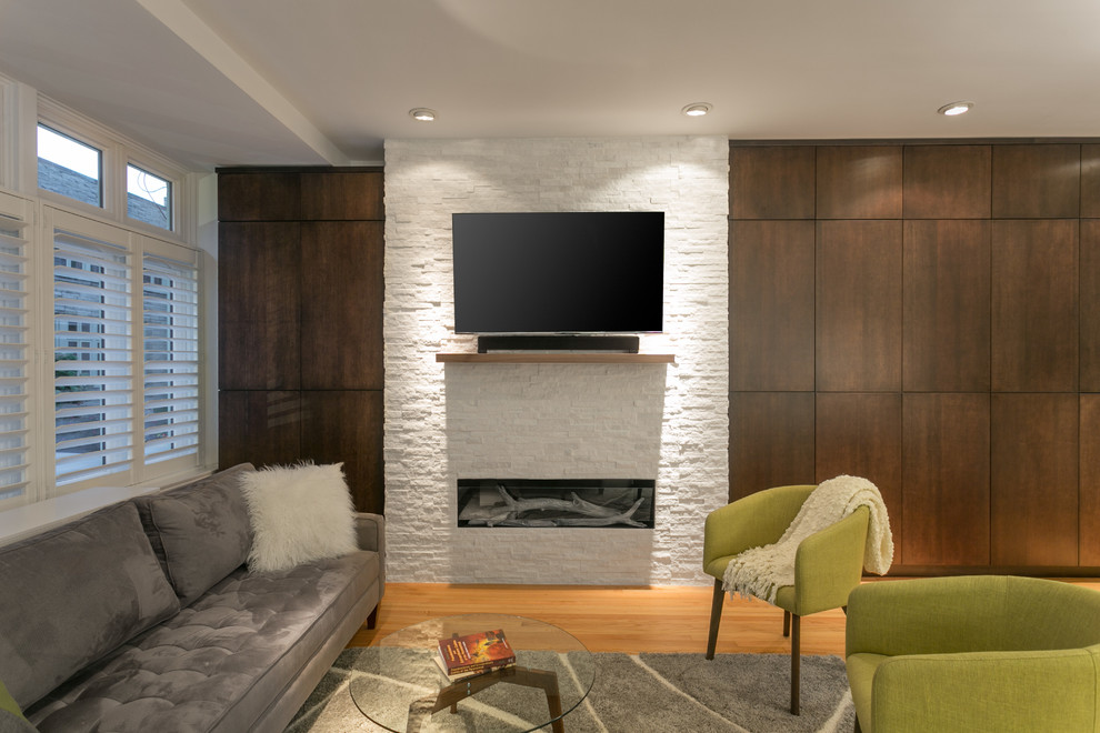 Photo of a medium sized contemporary formal mezzanine living room in Chicago with beige walls, medium hardwood flooring, a standard fireplace, a concrete fireplace surround and a built-in media unit.