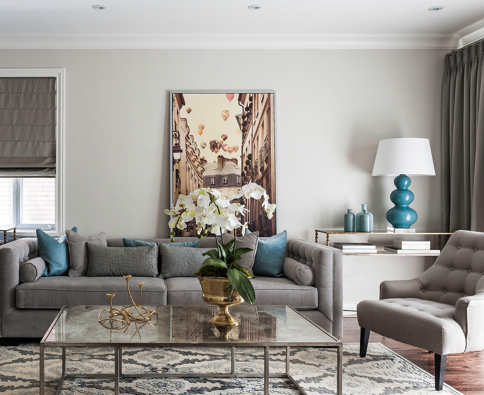 Medium sized traditional formal and grey and teal enclosed living room in Montreal with grey walls, medium hardwood flooring and no fireplace.