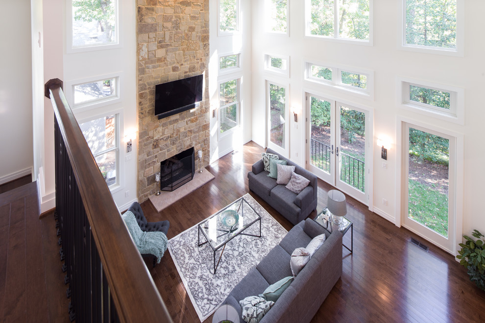 Mid-sized transitional formal and open concept medium tone wood floor and brown floor living room photo in DC Metro with white walls, a standard fireplace, a stone fireplace and no tv