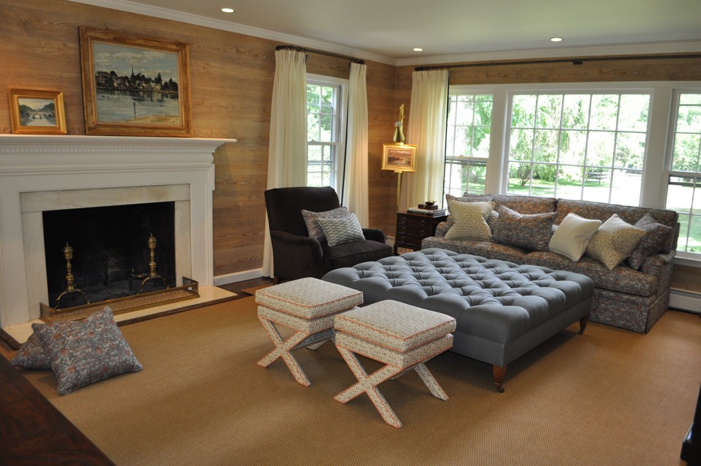 This is an example of a medium sized traditional enclosed living room in New York with a reading nook, beige walls, carpet, a standard fireplace, a stone fireplace surround and a freestanding tv.