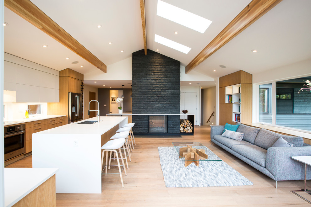 Inspiration for a large contemporary formal open plan living room in Vancouver with white walls, light hardwood flooring, a two-sided fireplace, no tv and a stone fireplace surround.