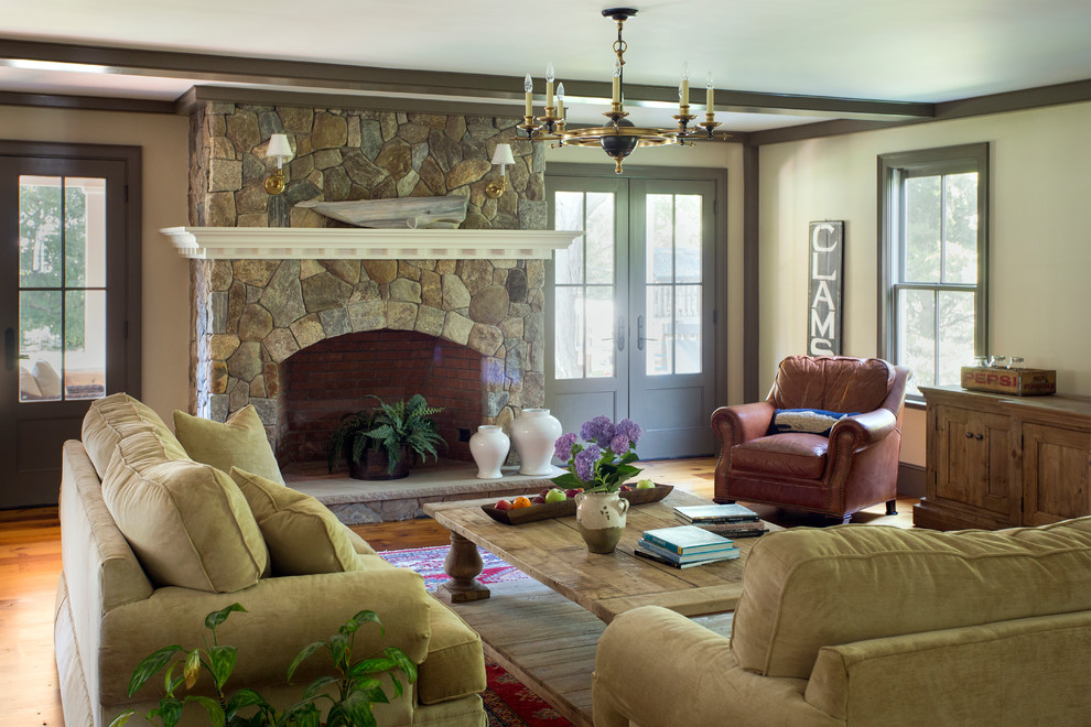 Example of a large farmhouse open concept and formal light wood floor living room design in Boston with beige walls, a stone fireplace, no tv and a standard fireplace