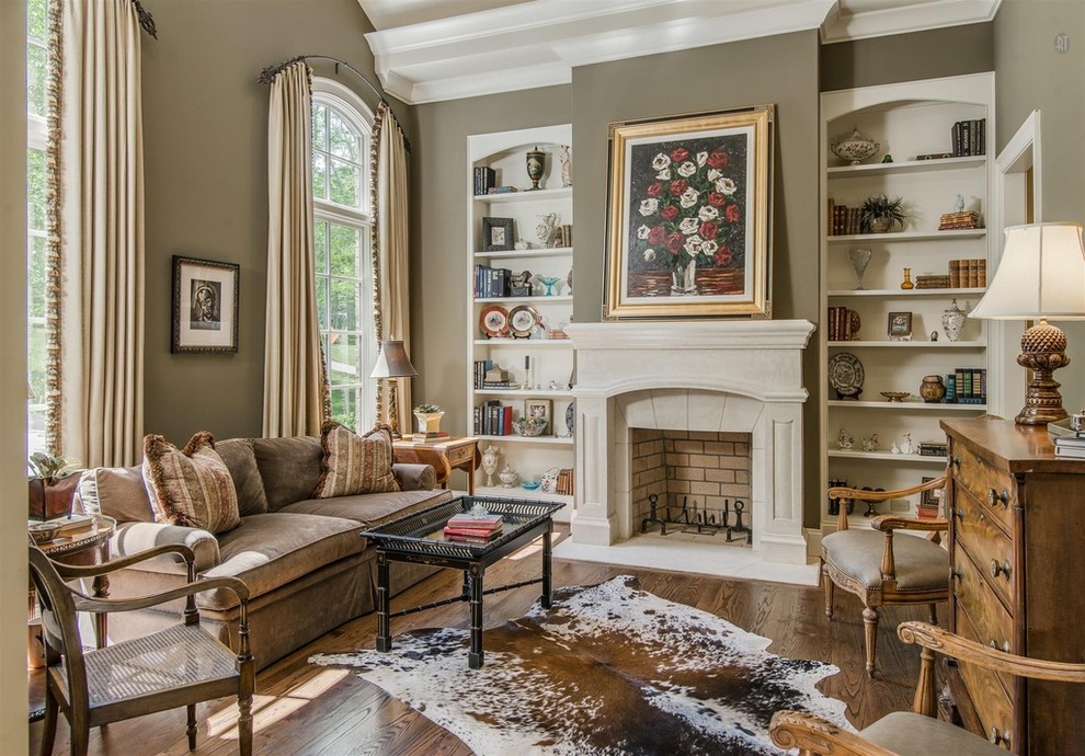 Inspiration for a traditional enclosed living room in Nashville with brown walls, a standard fireplace, a stone fireplace surround, no tv and medium hardwood flooring.