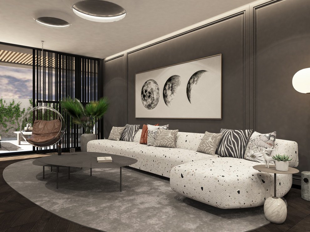 Ejemplo de salón tipo loft moderno grande con suelo marrón, paredes negras, suelo de madera oscura, televisor retractable, bandeja y panelado