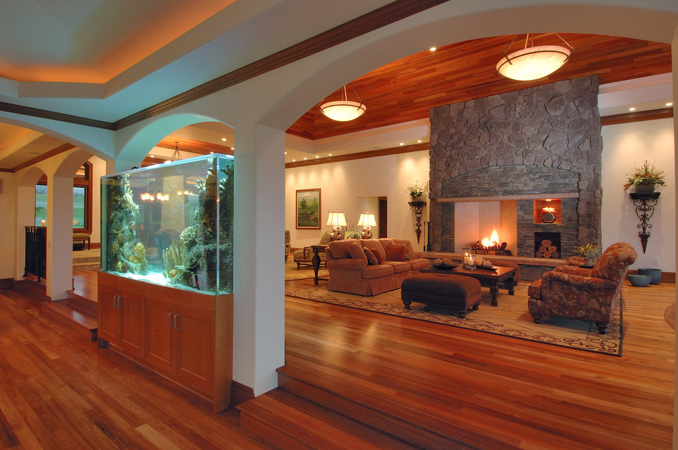 Example of a large trendy formal and open concept medium tone wood floor and brown floor living room design in Hawaii with a stone fireplace, white walls, a standard fireplace and no tv