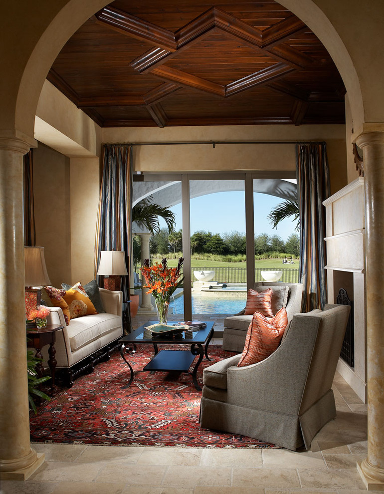На фото: гостиная комната в средиземноморском стиле с бежевыми стенами, стандартным камином и красивыми шторами с