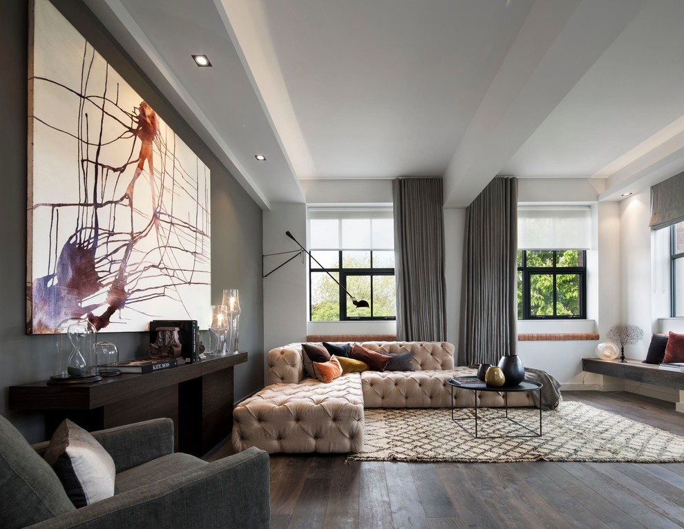 Photo of a contemporary open plan living room in London with dark hardwood flooring and white walls.