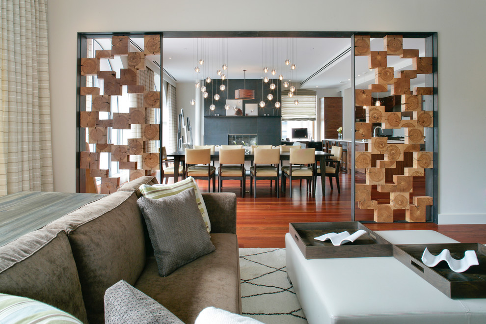Inspiration för mellanstora moderna vardagsrum, med vita väggar, mellanmörkt trägolv, en standard öppen spis och en spiselkrans i betong