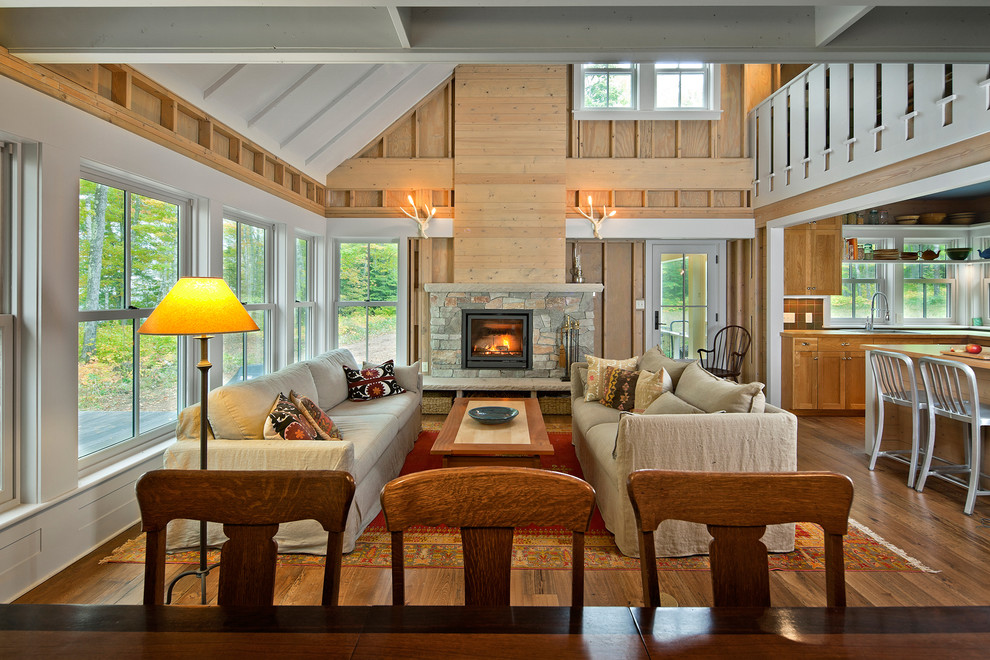 Example of a farmhouse formal and open concept living room design in Minneapolis with a standard fireplace and a stone fireplace
