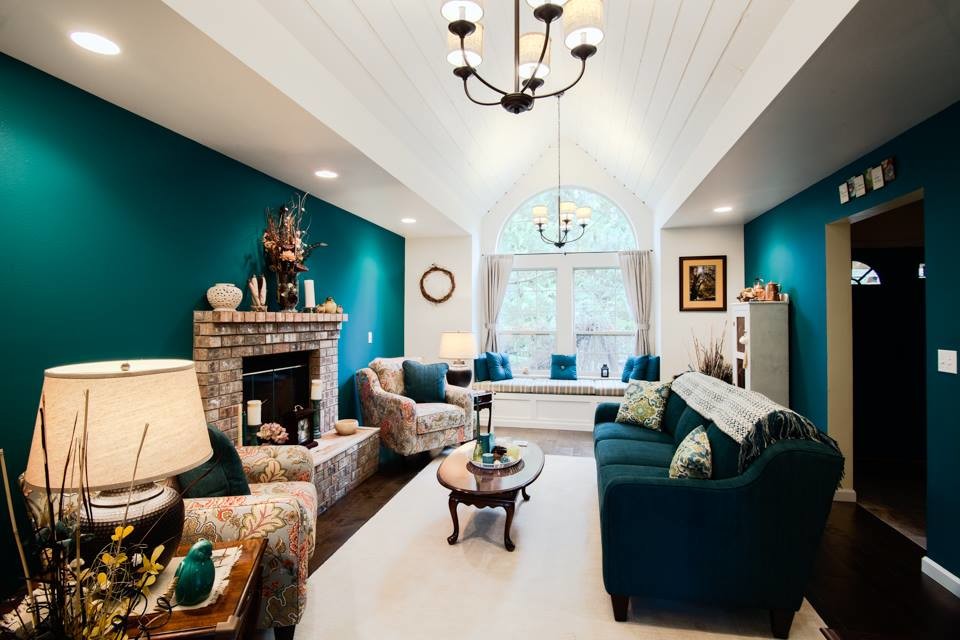 Photo of a medium sized country formal enclosed living room in Seattle with blue walls, dark hardwood flooring, a standard fireplace, a brick fireplace surround, no tv and brown floors.