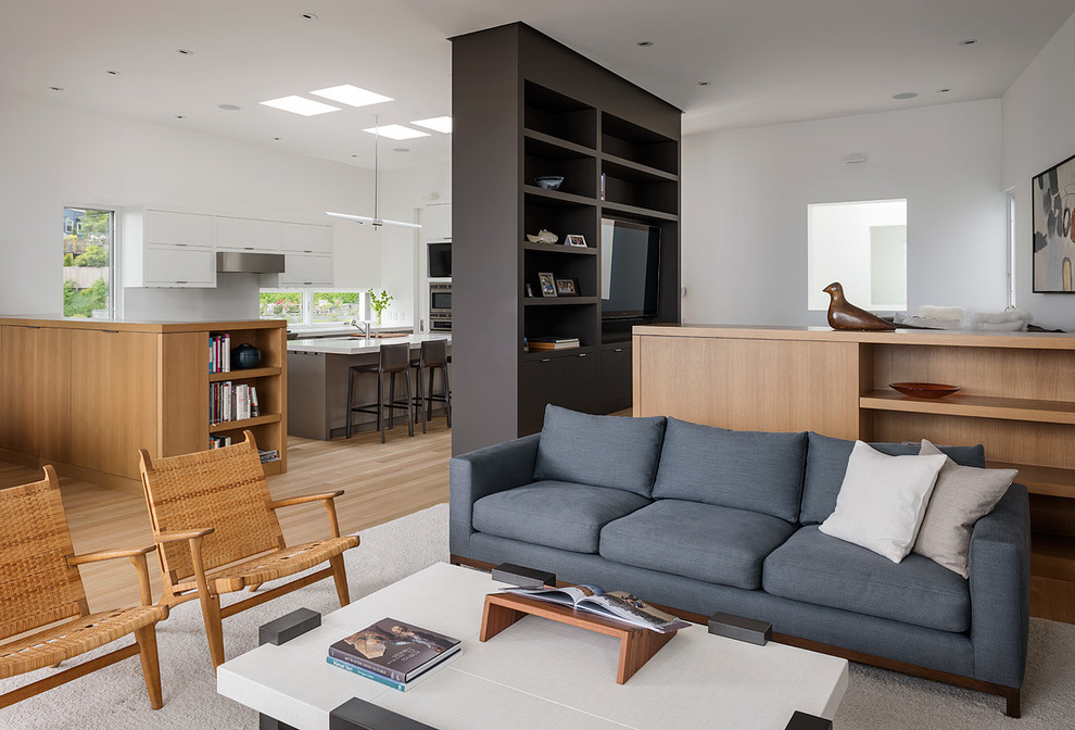 Example of a mid-sized minimalist open concept light wood floor living room design in Seattle with white walls