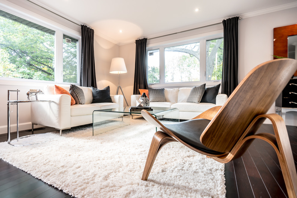 Medium sized modern open plan living room in Montreal with dark hardwood flooring.