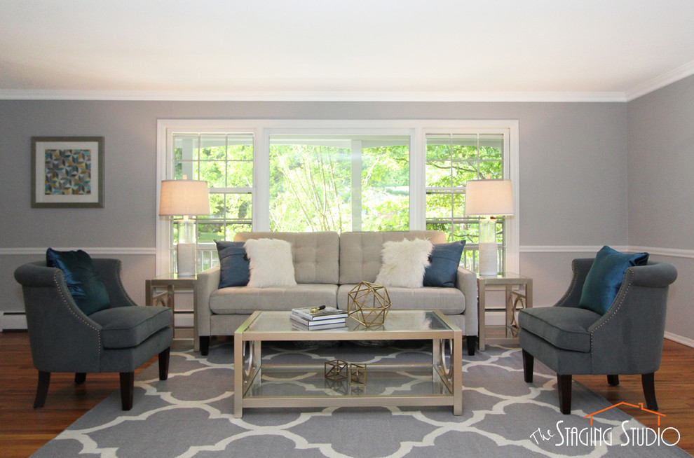 This is an example of a medium sized modern formal open plan living room in New York with grey walls, light hardwood flooring, no fireplace and no tv.