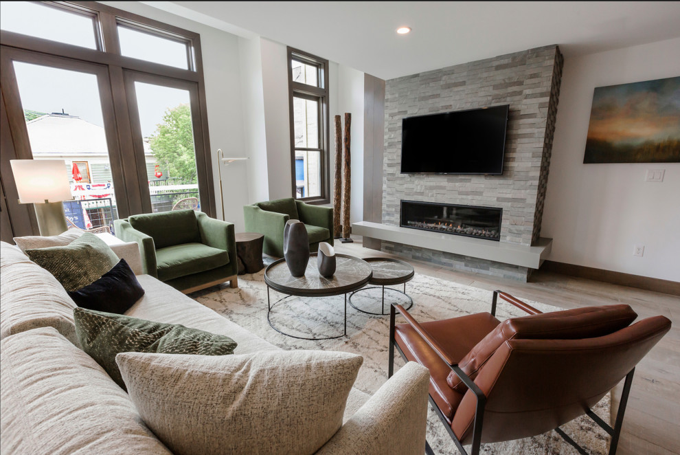 Design ideas for a small contemporary open plan living room in Salt Lake City with light hardwood flooring, a standard fireplace, a tiled fireplace surround and a wall mounted tv.