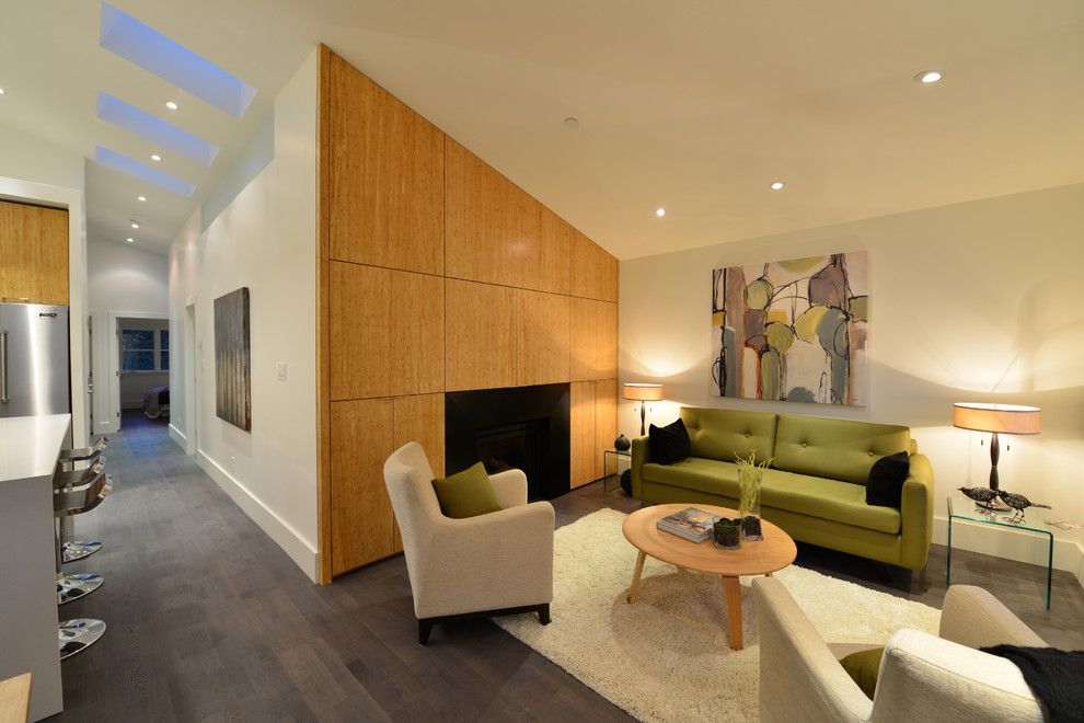 This is an example of a contemporary living room in Vancouver with beige walls and a standard fireplace.