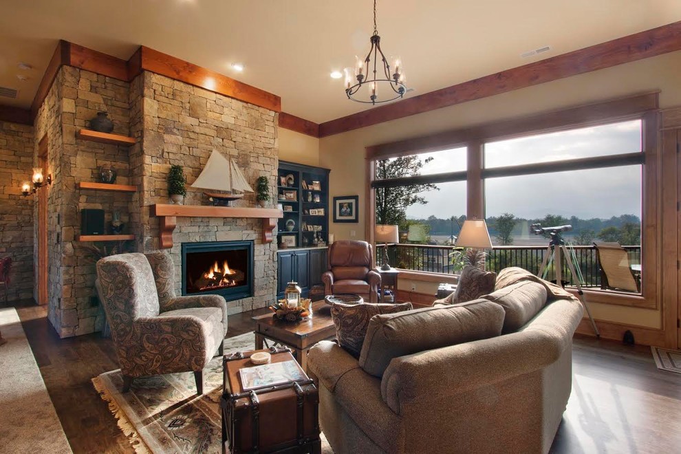 Medium sized rustic formal open plan living room in Other with beige walls, dark hardwood flooring, a standard fireplace, a stone fireplace surround, no tv and brown floors.
