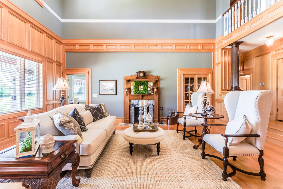 Klassisches Wohnzimmer mit grauer Wandfarbe, braunem Holzboden und Kamin in Kansas City