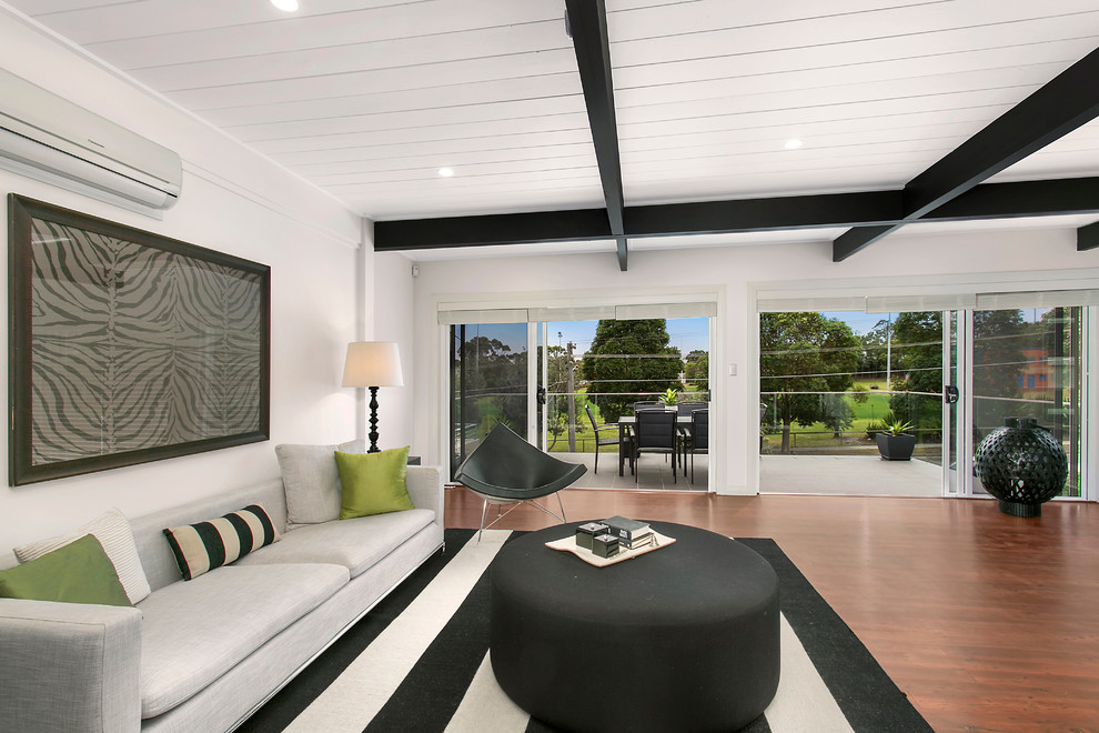 Design ideas for a classic formal living room in Sydney with white walls and dark hardwood flooring.