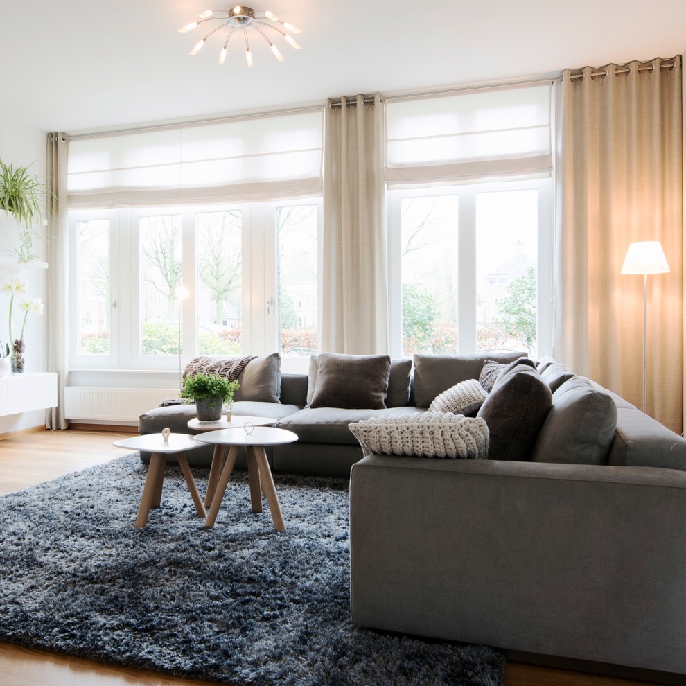 Example of a large trendy open concept light wood floor living room design in Amsterdam