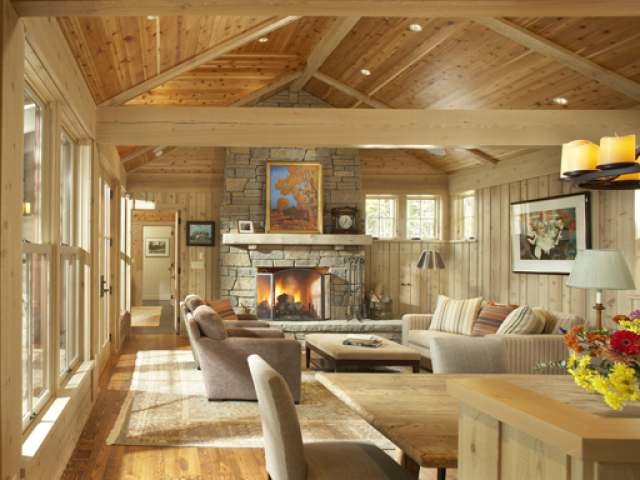 Imagen de salón para visitas abierto rural grande con suelo de madera en tonos medios, todas las chimeneas y marco de chimenea de piedra