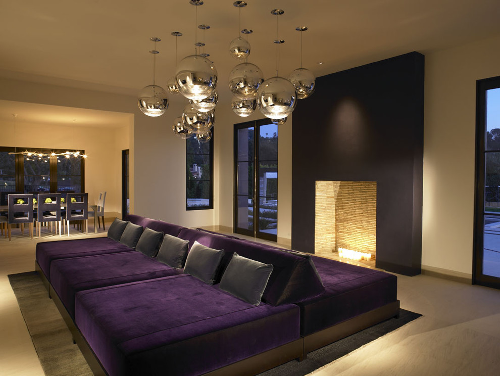 Example of a trendy open concept living room design in San Diego with beige walls and a standard fireplace