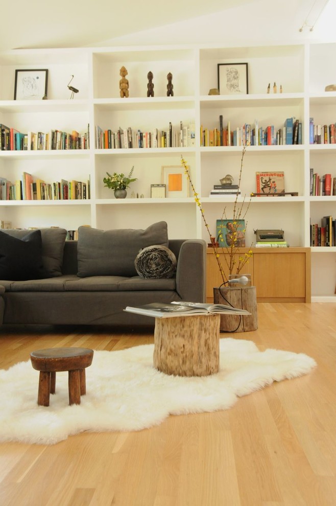 This is an example of a medium sized scandi open plan living room in Los Angeles with light hardwood flooring.