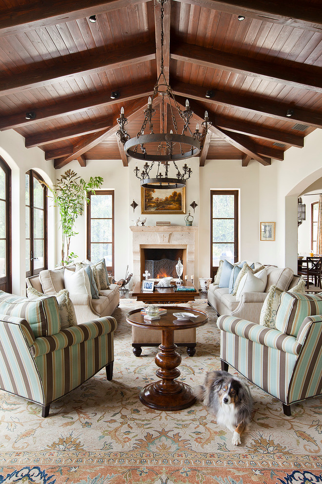Example of a large tuscan formal medium tone wood floor living room design in Los Angeles with white walls