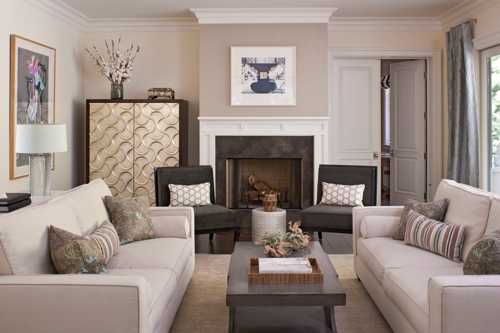 This is an example of a contemporary living room in Los Angeles with beige walls, a standard fireplace and no tv.