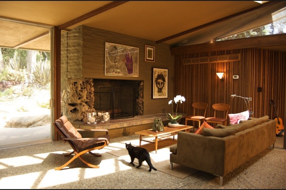 Example of a large mid-century modern open concept living room design in Los Angeles with brown walls, a standard fireplace, a stone fireplace and no tv
