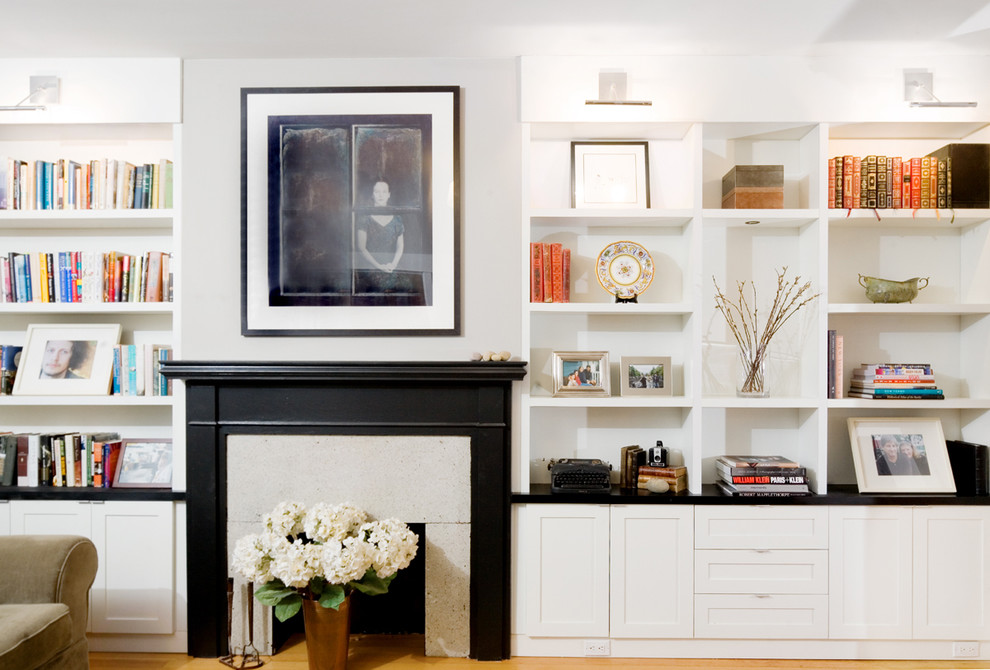 Example of a minimalist living room library design in Vancouver with a standard fireplace