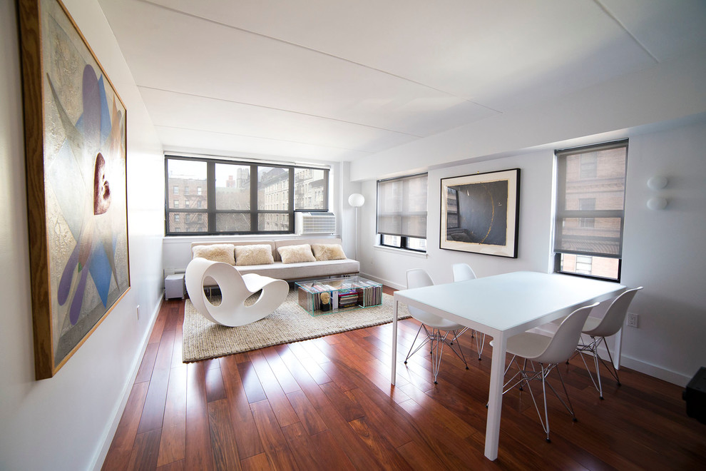 Mittelgroßes, Abgetrenntes, Fernseherloses Modernes Wohnzimmer ohne Kamin mit weißer Wandfarbe, dunklem Holzboden und rotem Boden in New York